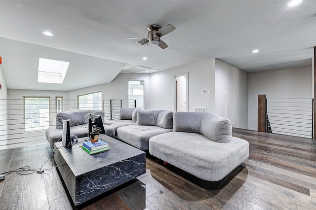 living area with visible vents, a skylight, hardwood / wood-style flooring, and recessed lighting