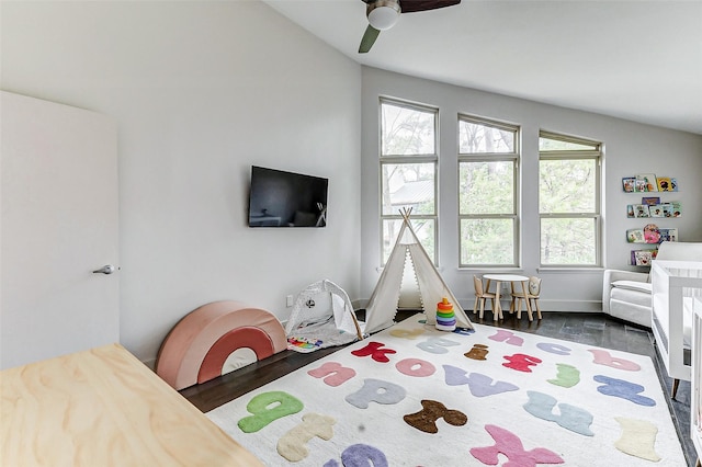 bedroom with ceiling fan, multiple windows, and vaulted ceiling