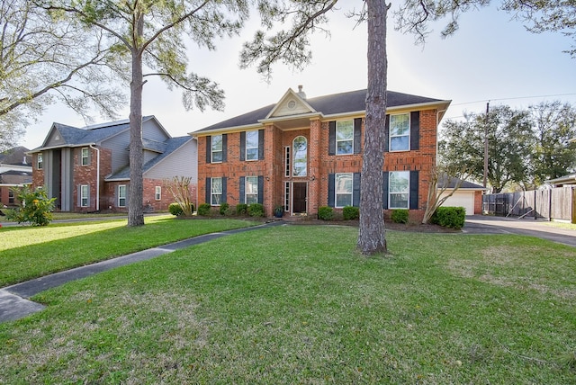 view of front of house with a front yard, fence, brick siding, and a chimney