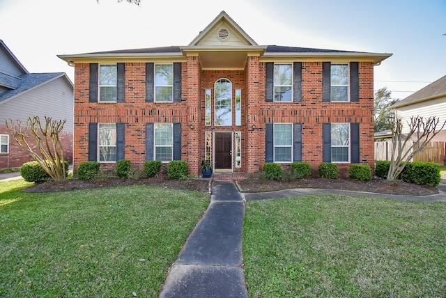 view of front of property featuring a front lawn and brick siding