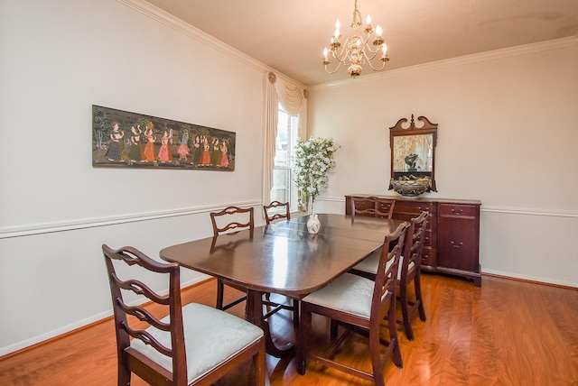 dining space with wood finished floors, baseboards, and ornamental molding