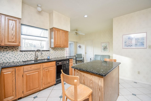 kitchen with a sink, a kitchen island, dark stone counters, baseboards, and dishwasher