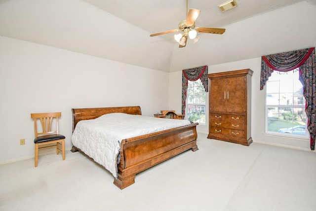 bedroom with visible vents, baseboards, lofted ceiling, light colored carpet, and ceiling fan