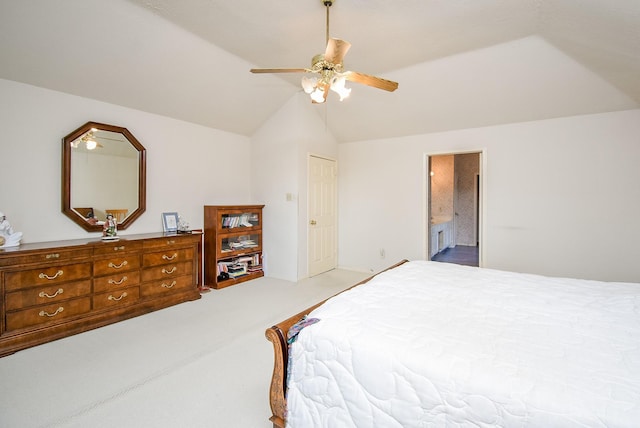 bedroom featuring connected bathroom, carpet floors, a ceiling fan, and vaulted ceiling