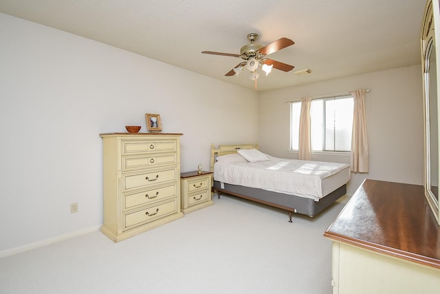 bedroom featuring carpet flooring, a ceiling fan, and visible vents