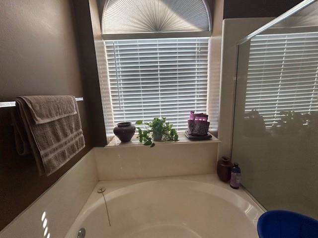 full bathroom with a garden tub