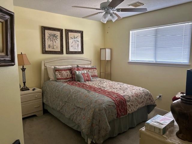 bedroom featuring carpet, visible vents, and ceiling fan