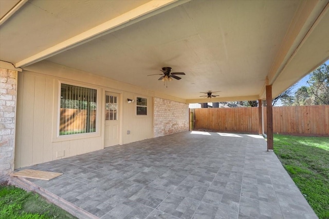 view of patio with ceiling fan and fence