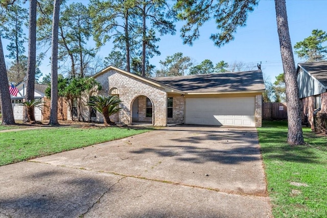 view of front of house with a garage, a front yard, concrete driveway, and fence