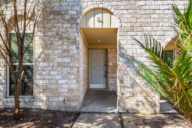 doorway to property featuring stone siding