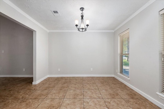 spare room featuring ornamental molding, light tile patterned flooring, baseboards, and an inviting chandelier