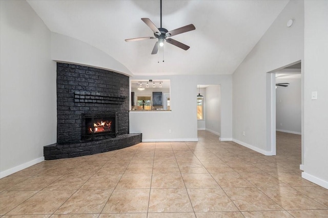 unfurnished living room featuring vaulted ceiling, ceiling fan, and baseboards