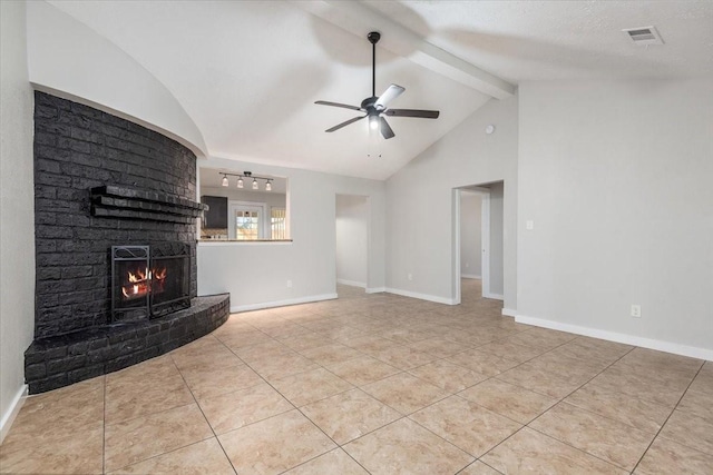 unfurnished living room with lofted ceiling with beams, a brick fireplace, visible vents, and baseboards