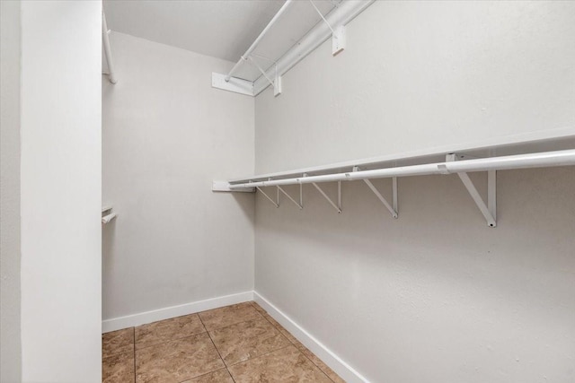 spacious closet featuring tile patterned flooring