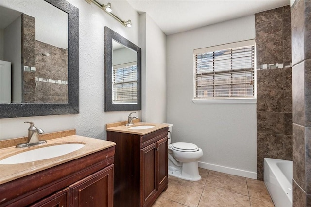 bathroom with two vanities, a sink, toilet, and tile patterned floors