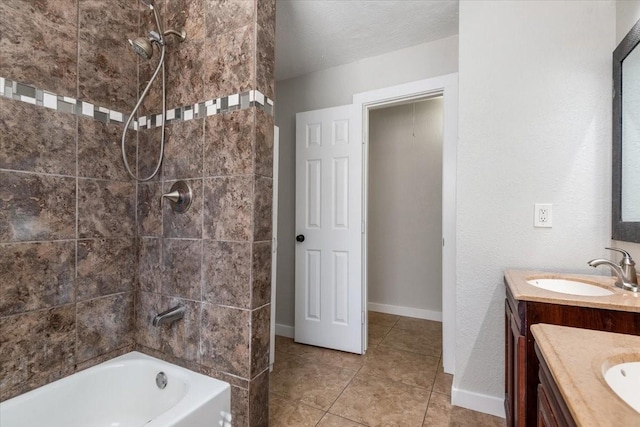 full bath with a textured ceiling, vanity, baseboards, tile patterned floors, and washtub / shower combination