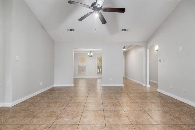 unfurnished room featuring light tile patterned floors, ceiling fan, visible vents, and arched walkways