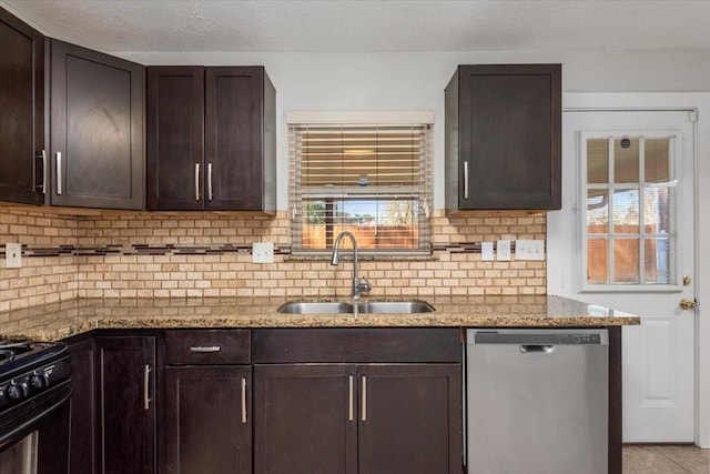 kitchen with dark brown cabinetry, light stone countertops, a sink, stainless steel dishwasher, and decorative backsplash