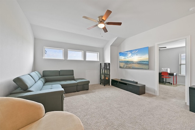 carpeted living room with lofted ceiling, baseboards, and a ceiling fan