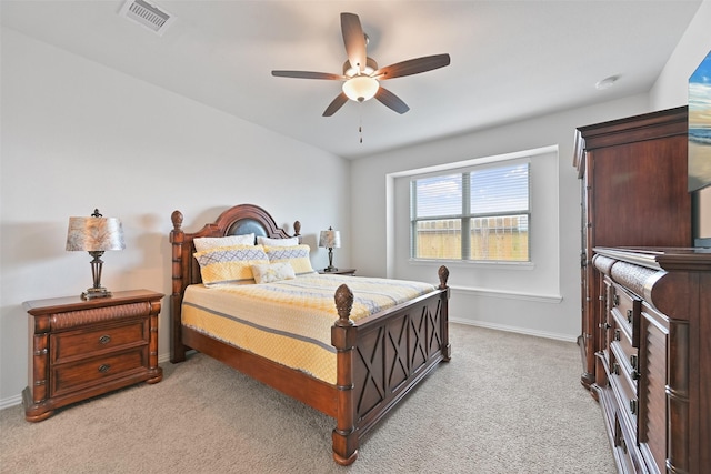 bedroom featuring baseboards, a ceiling fan, visible vents, and light colored carpet