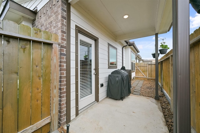 view of patio / terrace with fence private yard and a grill