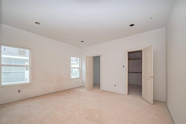 unfurnished bedroom with a spacious closet