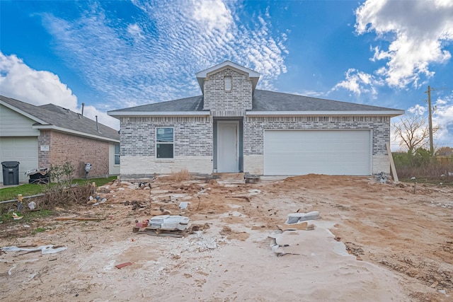 view of front of property featuring brick siding and an attached garage