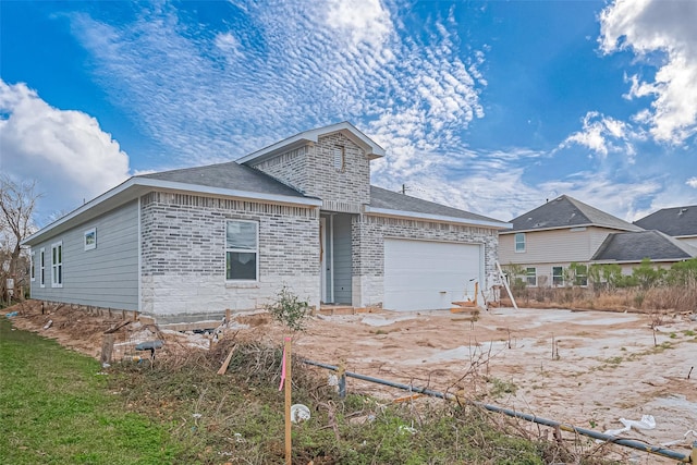 view of front facade with an attached garage and brick siding