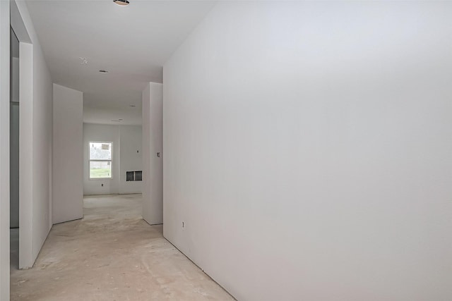 hallway featuring unfinished concrete flooring