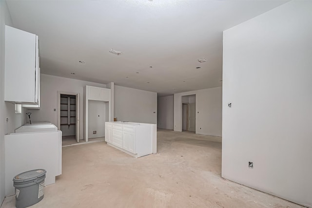 interior space with white cabinets and concrete floors