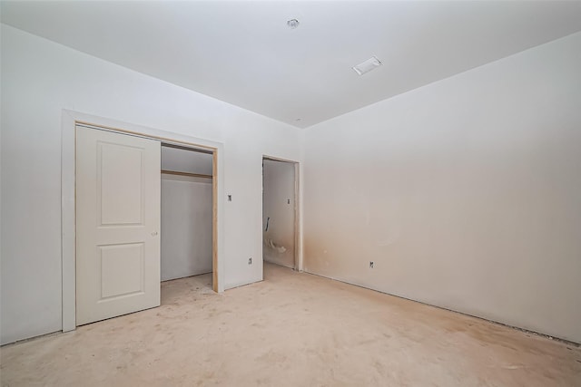 unfurnished bedroom featuring unfinished concrete floors