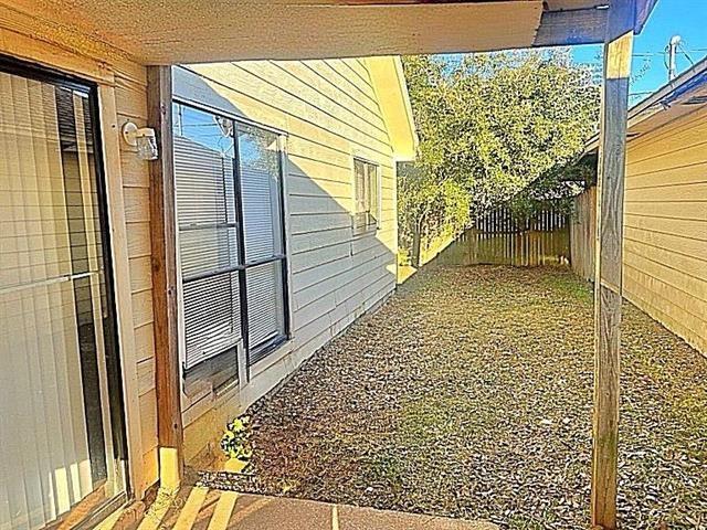 view of side of home featuring a fenced backyard