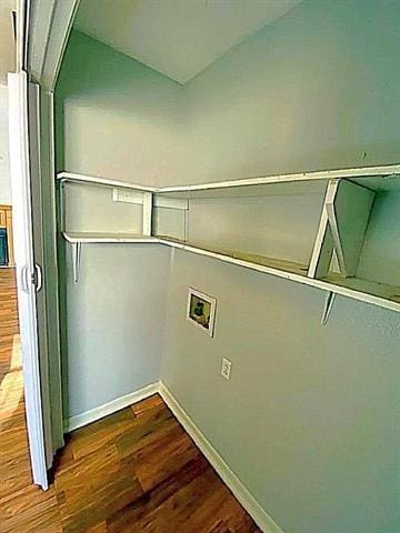 washroom with hookup for a washing machine, dark wood finished floors, and baseboards