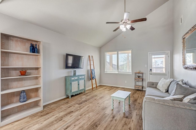 living area with visible vents, baseboards, ceiling fan, wood finished floors, and high vaulted ceiling