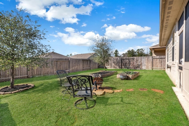 view of yard with a fenced backyard and a vegetable garden