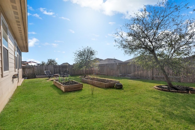 view of yard featuring a fenced backyard and a vegetable garden