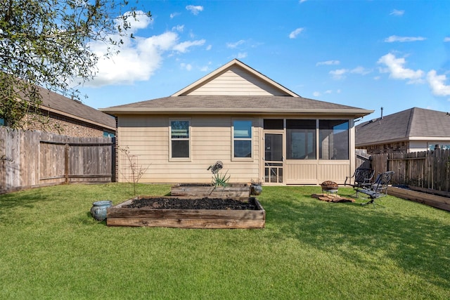 rear view of property featuring an outdoor fire pit, a fenced backyard, a lawn, and a vegetable garden