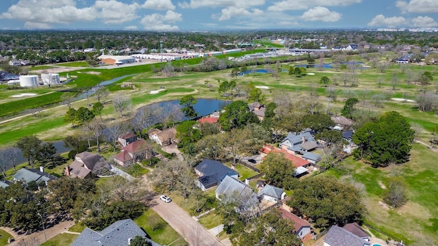 drone / aerial view with golf course view, a water view, and a residential view