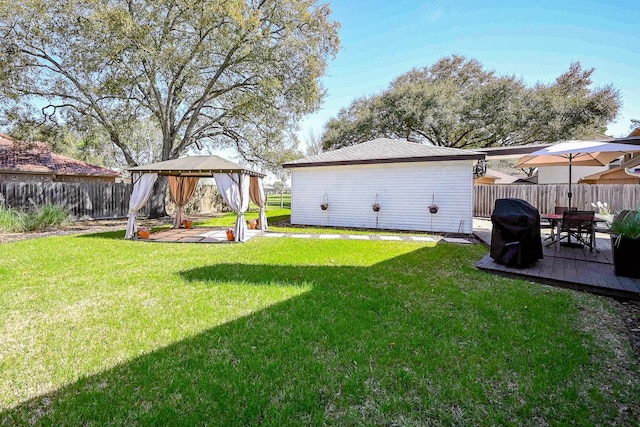 view of yard featuring a deck, a gazebo, and a fenced backyard