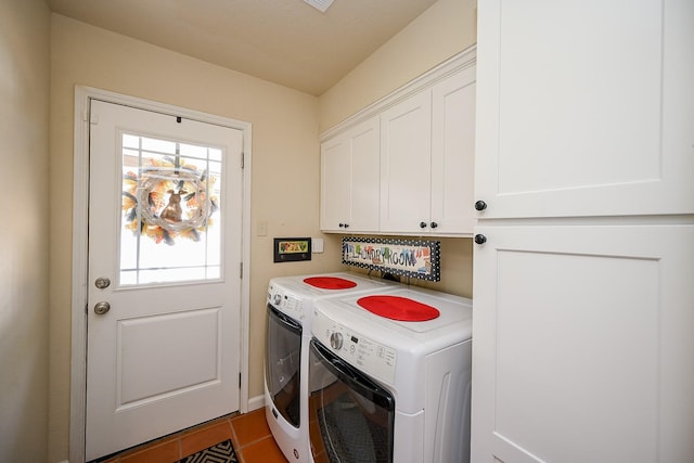 laundry room featuring cabinet space, washing machine and dryer, and tile patterned flooring