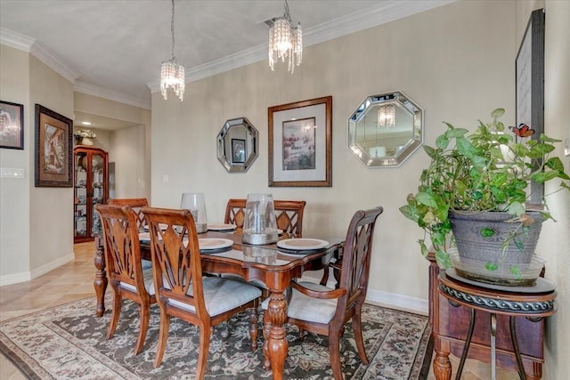 dining room featuring an inviting chandelier, baseboards, and crown molding