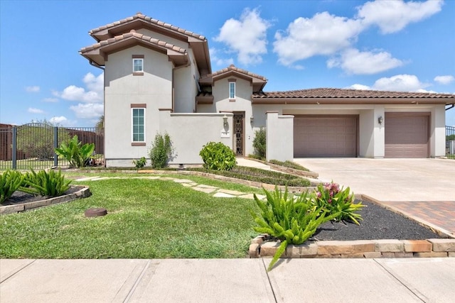 mediterranean / spanish-style home featuring concrete driveway, a tiled roof, an attached garage, fence, and stucco siding