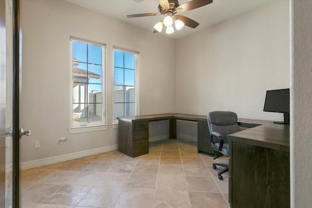 home office featuring light tile patterned floors, a ceiling fan, and baseboards