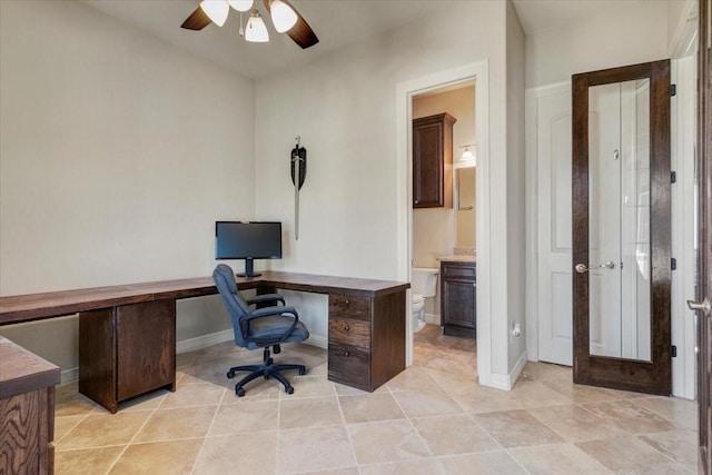 office space with ceiling fan, light tile patterned floors, and baseboards