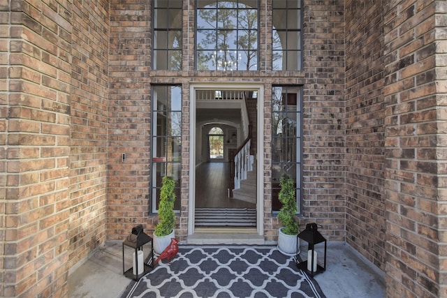 doorway to property with brick siding