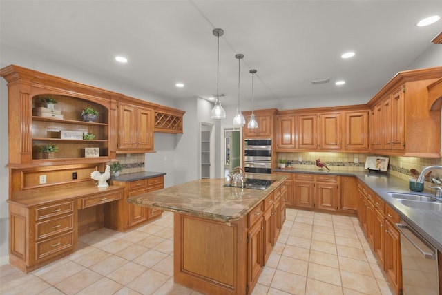 kitchen with light tile patterned flooring, a kitchen island, a sink, appliances with stainless steel finishes, and built in study area