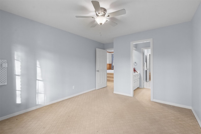 unfurnished bedroom featuring baseboards and ensuite bathroom