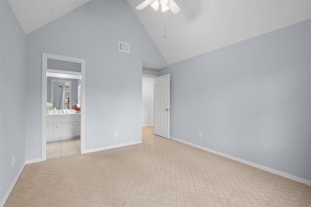 unfurnished bedroom with high vaulted ceiling, connected bathroom, a ceiling fan, visible vents, and baseboards