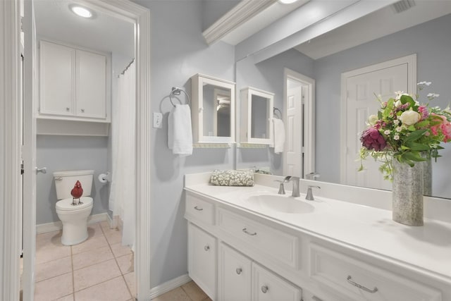 full bathroom featuring toilet, tile patterned flooring, vanity, and baseboards