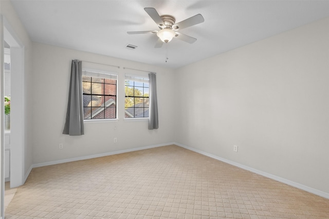 empty room featuring a ceiling fan, visible vents, and baseboards